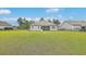 Spacious backyard with lawn, fence, screened in porch on house and neighboring homes at 431 Canal Crossing Way, Huger, SC 29450