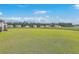 Expansive backyard featuring a lush lawn, bordered by a fence, with neighborhood homes in the background at 431 Canal Crossing Way, Huger, SC 29450