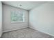 Bright bedroom with neutral carpet and a large window at 431 Canal Crossing Way, Huger, SC 29450