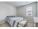 Minimalist bedroom with a bed, window, and neutral decor, offering a calming and uncluttered space at 431 Canal Crossing Way, Huger, SC 29450