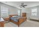 Bedroom with ample natural light from three windows and traditional wood furniture at 431 Canal Crossing Way, Huger, SC 29450
