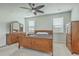 Bright bedroom featuring wood furniture, neutral paint, carpet, and a modern ceiling fan with a light at 431 Canal Crossing Way, Huger, SC 29450