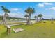 Outdoor horseshoe pit with a sand pit with lush green grass and palm trees at 431 Canal Crossing Way, Huger, SC 29450