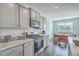 Well-appointed kitchen with modern appliances and countertops, open to an adjacent breakfast nook at 431 Canal Crossing Way, Huger, SC 29450