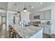 Spacious kitchen features stainless steel appliances, granite countertops, and a large central island with bar stool seating at 431 Canal Crossing Way, Huger, SC 29450