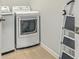 Convenient laundry room equipped with modern washer and dryer units and essential cleaning supplies at 431 Canal Crossing Way, Huger, SC 29450