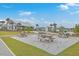 Community picnic area offers multiple wooden picnic tables and covered building with palm trees and gravel at 431 Canal Crossing Way, Huger, SC 29450
