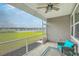 Relax on this screened porch with wicker seating and a view of the lake and backyard at 431 Canal Crossing Way, Huger, SC 29450