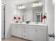 Bright bathroom featuring a double vanity with white cabinets, a large mirror, and stylish fixtures at 435 Foxbank Plantation Blvd Blvd, Moncks Corner, SC 29461