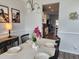Well-lit dining room featuring a modern table setting and hardwood floors, leading to the kitchen at 435 Foxbank Plantation Blvd Blvd, Moncks Corner, SC 29461