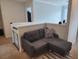 Landing area with gray couch and striped pillow and rug, with white banister and baby gate at 435 Foxbank Plantation Blvd Blvd, Moncks Corner, SC 29461