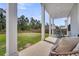 Inviting back porch with seating, offering a view of the backyard and mature trees at 435 Woodgate Way, Summerville, SC 29485