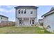 A spacious backyard featuring a two-story home, a detached garage, and a well-maintained lawn at 435 Woodgate Way, Summerville, SC 29485