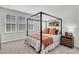 Bedroom featuring a bed with black frame, cozy linens, and a view from the windows at 435 Woodgate Way, Summerville, SC 29485