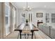 Bright dining room features a long wooden table with modern chairs and natural light at 435 Woodgate Way, Summerville, SC 29485