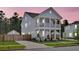 Charming two-story home with a welcoming front porch and lush landscaping at 435 Woodgate Way, Summerville, SC 29485