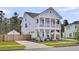 Charming two-story home featuring a double porch, meticulously landscaped yard, and a welcoming driveway at 435 Woodgate Way, Summerville, SC 29485