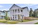 Charming two-story home featuring a double porch, meticulously landscaped yard, and a welcoming driveway at 435 Woodgate Way, Summerville, SC 29485