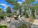 Inviting community fire pit area with Adirondack chairs and lush landscaping at 435 Woodgate Way, Summerville, SC 29485