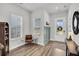 Bright foyer with hardwood floors, large windows, and stylish decor, creating a welcoming entrance at 435 Woodgate Way, Summerville, SC 29485
