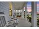 Inviting front porch with rocking chairs, supported by classic columns, offers a relaxing outdoor space at 435 Woodgate Way, Summerville, SC 29485