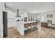 Modern kitchen with white cabinets, a large island with seating, and stainless steel appliances at 435 Woodgate Way, Summerville, SC 29485