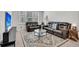 Living room with plush brown leather sofas, a modern rug, and plenty of natural light at 435 Woodgate Way, Summerville, SC 29485