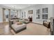 Comfortable living area with sectional sofa, wood flooring, and large windows for natural light at 435 Woodgate Way, Summerville, SC 29485