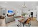 Open-concept living room and kitchen area, showcasing modern lighting and comfortable seating at 435 Woodgate Way, Summerville, SC 29485