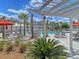 Relaxing community pool area with lounge chairs and palm trees at 435 Woodgate Way, Summerville, SC 29485