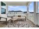 Cozy outdoor porch seating arrangement with comfortable furniture and neighborhood views at 435 Woodgate Way, Summerville, SC 29485