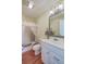 Bathroom with white vanity, framed mirror, decorative vase, bathtub, shower, and wooden floor at 4401 Prices Bridge Ln, Walterboro, SC 29488