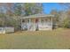 Front exterior view of the home with covered porch, stairs, railing, and lawn at 4401 Prices Bridge Ln, Walterboro, SC 29488