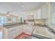 Bright kitchen featuring white cabinets, updated appliances, and a breakfast bar with seating at 4401 Prices Bridge Ln, Walterboro, SC 29488