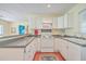 Well-lit kitchen with white cabinetry, updated appliances, and a breakfast bar for casual dining at 4401 Prices Bridge Ln, Walterboro, SC 29488