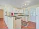 Functional kitchen featuring white cabinets, a breakfast bar, and convenient access to the outdoors at 4401 Prices Bridge Ln, Walterboro, SC 29488