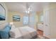 Bedroom features hardwood floors, ceiling fan, artwork, and a bed with blue accents at 4401 Prices Bridge Ln, Walterboro, SC 29488