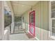 Covered porch with a red screen door, rocking chairs, a window, and a view of the side yard at 4401 Prices Bridge Ln, Walterboro, SC 29488