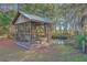 Screened porch with a swing overlooking the beautiful pond and backyard at 4401 Prices Bridge Ln, Walterboro, SC 29488