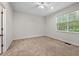 Inviting bedroom featuring neutral carpeting and a bright window overlooking greenery at 4591 Great Oak Dr, North Charleston, SC 29418