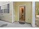 A covered entryway reveals a glimpse into a foyer with wood floors, bright lighting, and a staircase at 4591 Great Oak Dr, North Charleston, SC 29418