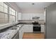 Bright kitchen features white cabinets, stainless steel appliances, and sleek countertops for a modern look at 4591 Great Oak Dr, North Charleston, SC 29418
