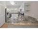 Modern kitchen with stainless appliances, stylish countertops, and ample cabinet space with view of dining area at 4591 Great Oak Dr, North Charleston, SC 29418