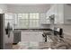 This kitchen features stainless appliances, stylish countertops, and ample cabinet space with view of dining area at 4591 Great Oak Dr, North Charleston, SC 29418