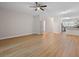 This spacious living room features wood floors and a view of the kitchen and a view to outside at 4591 Great Oak Dr, North Charleston, SC 29418