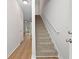 The staircase leads to the upper level with plush carpet, a white railing, and natural light at 4591 Great Oak Dr, North Charleston, SC 29418