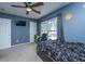 Bedroom featuring blue walls, a ceiling fan, and a window overlooking the backyard at 5088 Thornton Dr, Summerville, SC 29485