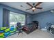 Comfortable bedroom with ceiling fan and a large window for natural light at 5088 Thornton Dr, Summerville, SC 29485