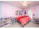 Bright bedroom with pink accent walls, ceiling fan and a cozy reading nook at 5088 Thornton Dr, Summerville, SC 29485