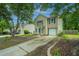View of the home showing the driveway and a neatly landscaped yard with fresh mulch at 5088 Thornton Dr, Summerville, SC 29485